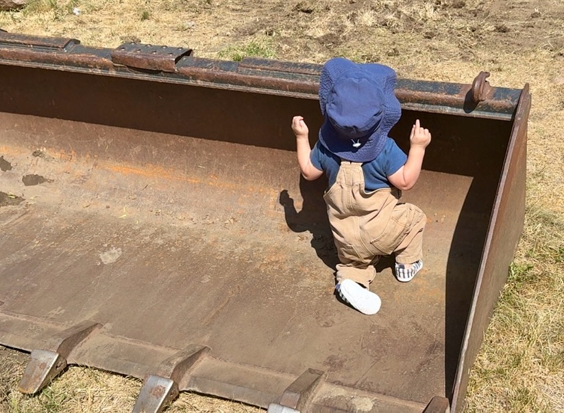 Young member of the J&J family on a landscaping job site